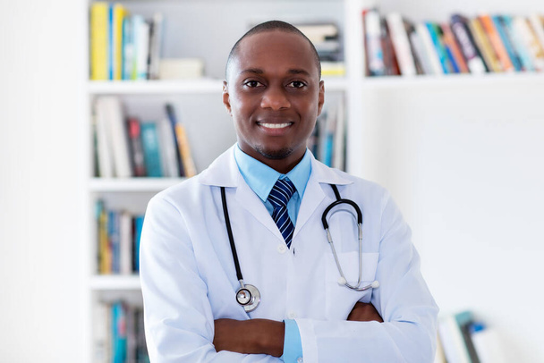 Portrait of afro american male doctor looking at camera at hospital - Фото, изображение