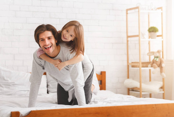 Dad and daughter having fun after waking up in morning - Fotó, kép