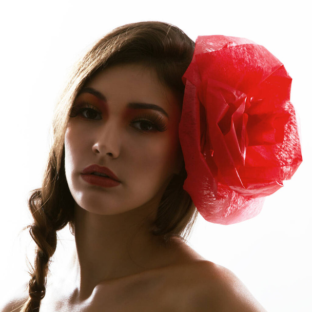 portrait of fashion glamour girl with red flower in her hair, studio shot - 写真・画像