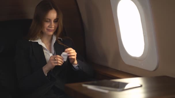 Attractive woman in private jet - Filmati, video