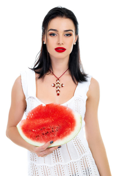 Beautiful young woman holding and eating slice of ripe red fresh juicy tasty sweet watermelon, isolated on white background. - 写真・画像