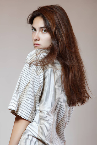 Fashion model. Young woman posing in studio. Beautiful caucasian girl over gray background, image toned. - Valokuva, kuva