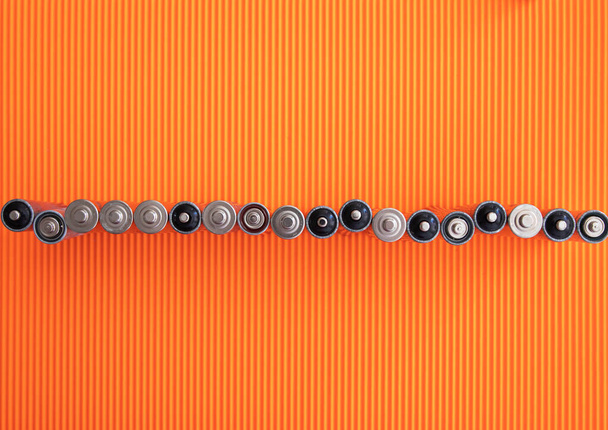 The silver aa batteries on an orange background - Photo, Image