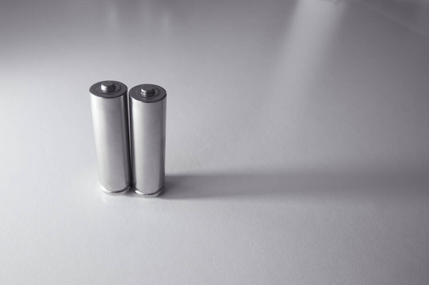 Two aa gray batteries on a white background - Foto, afbeelding