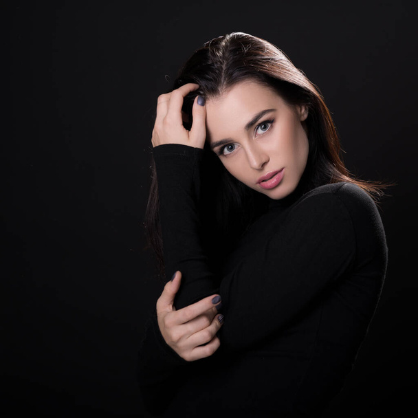 Beautiful girl posing over black background. Young pretty woman in studio. - Fotoğraf, Görsel