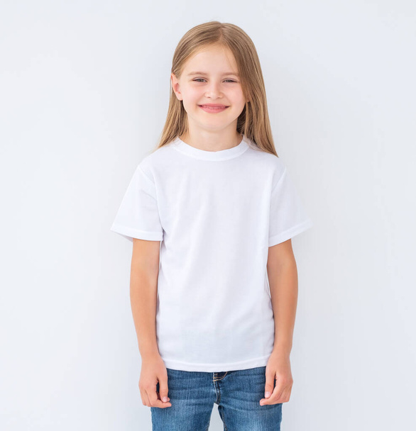 Little girl in white blank t-shirt, isolated - 写真・画像