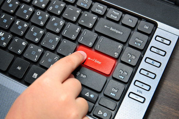 Finger of chind pushing the button of keyboard - Foto, Bild
