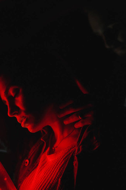 Muž dotýkající se jejího ženského krku v neonovém světle. Milostný příběh - Fotografie, Obrázek