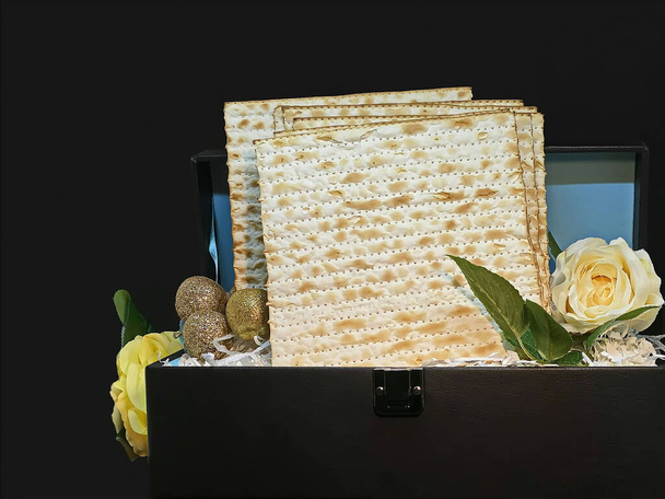 Pesach-Jewish easter. Feast in Passover. Matzah in gift leather chest with souvenir apples and roses - Photo, Image