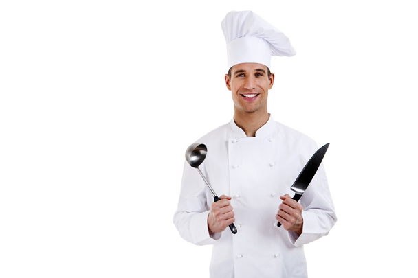 Chef. Isolated over white background. Holding knife and spoon - Fotografie, Obrázek
