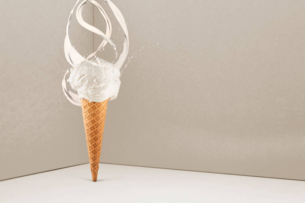 vanilla ice cream cone with splashing milk on colorful background - Photo, Image