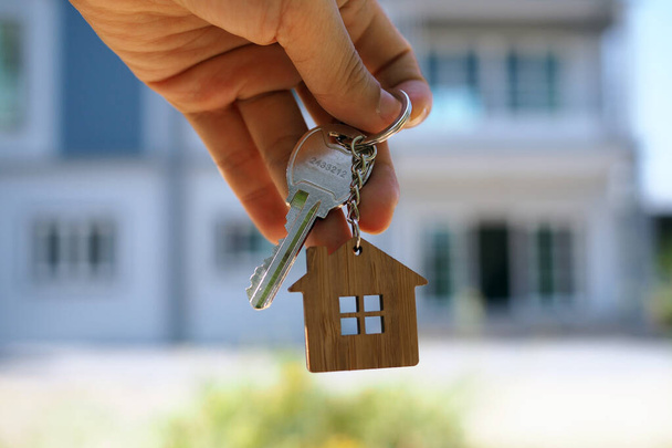 Landlord unlocks the house key for new home - Photo, Image