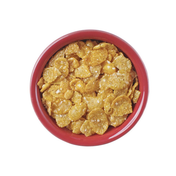 Honig und Nuss Cornflakes in einer roten Schüssel Isoliert auf weißem Hintergrund. Ansicht von oben. - Foto, Bild