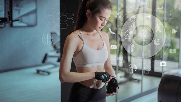 Fitness woman in gym with workout icons, health care technology concept   - Photo, Image