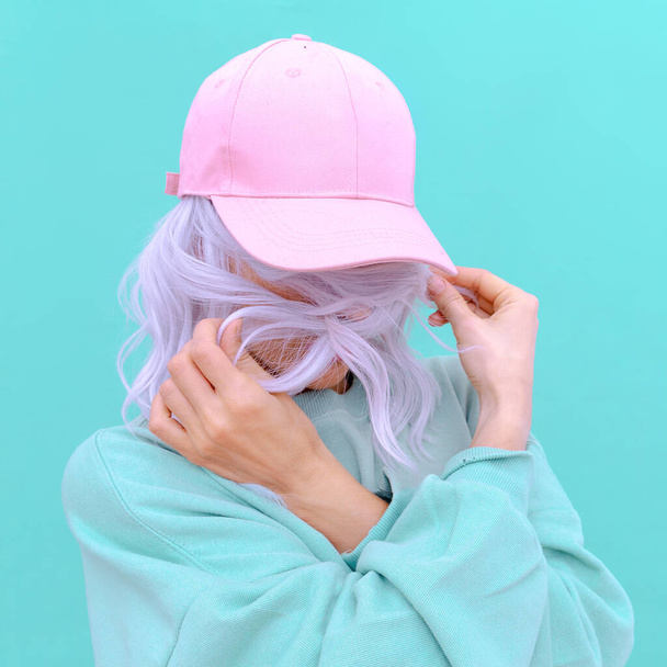 Aesthetic girl in stylish accessories b-boy cap. Fresh pastel colours monochrome fashion design trends - Фото, зображення