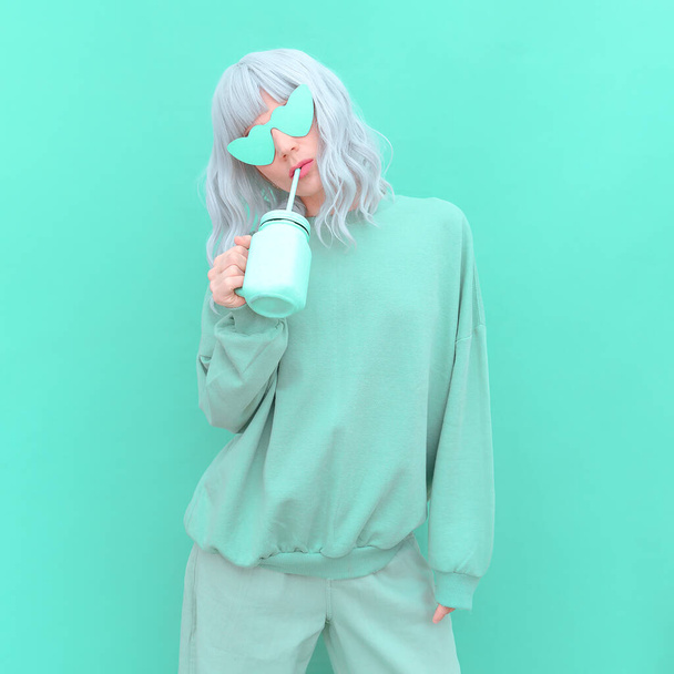 Aesthetic girl in stylish accessories sunglasses and fresh Smoothie. Mint monochrome colours design - Foto, afbeelding