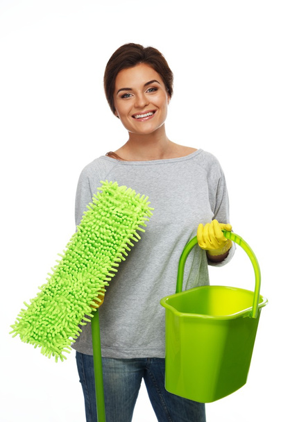 Beautiful cheerful brunette woman in gloves with mop and bucket - Photo, Image