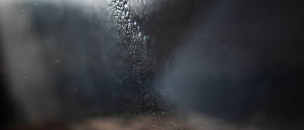 Pequeñas gotas de agua golpeadas por el sol en la forma de contra-jour abstracciones grises
 - Foto, imagen
