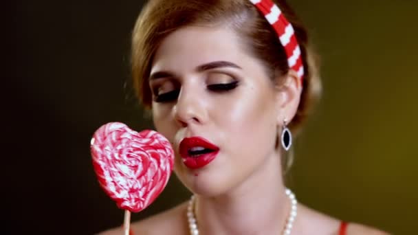 Woman retro style lick lollipop confection portrait - Footage, Video