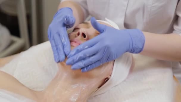 A profi kozmetikus megmos egy nőt és megmasszírozza az arcát.. - Felvétel, videó