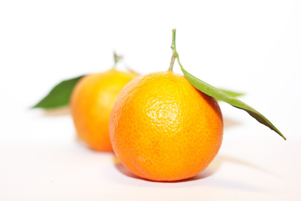 Orange mandarins with green leaf isolated on white background - Фото, изображение