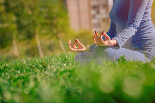 Hands closeup namaste. young Caucasian girl practices yoga meditation in the fresh air. The concept of peace of mind. Balance and harmony in life - Photo, image