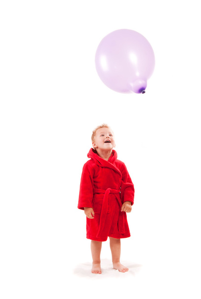 Surpreendido menino pequeno pagando com balão
 - Foto, Imagem