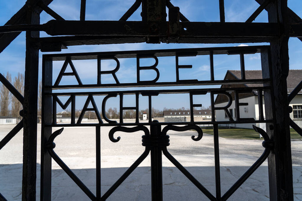 Dachau, Niemcy: 2 kwietnia 2019 r. - widok głównej bramy przy wejściu do Miejsca Pamięci Obozu Koncentracyjnego Dachau. praca ustawia darmowy znak na bramach obozu koncentracyjnego Dachau - Zdjęcie, obraz