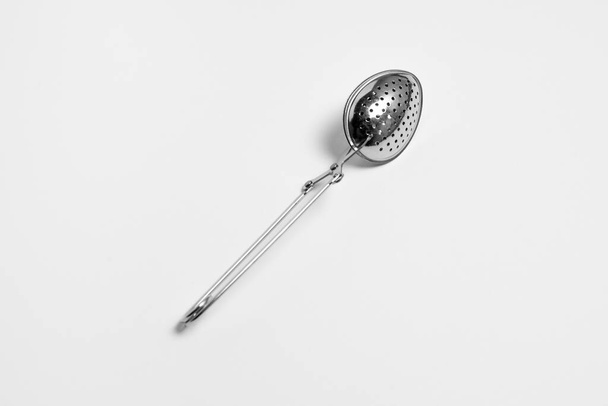 A stainless tea strainer. Still life of kitchenware.High-resolution photo.Top view. - Foto, Imagem