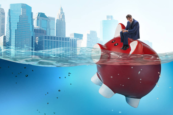 Empresario en concepto de deuda con Piggybank
 - Foto, Imagen
