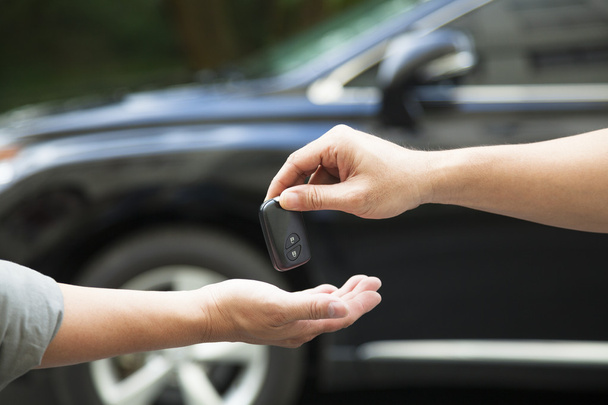 hands giving and receiving car key - Photo, Image