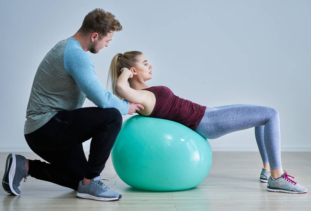 Woman with her personal fitness trainer - Fotoğraf, Görsel