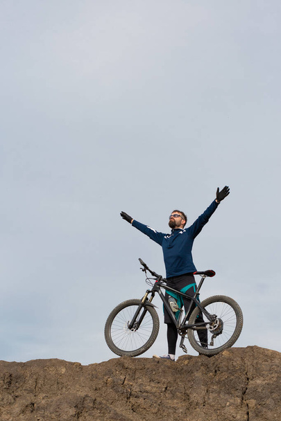 Bearded mountain bicyclist rides mountains - Foto, afbeelding