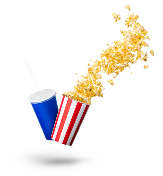 Paper striped bucket with popcorn and cup of soft drink isolated on white background, movie night concept or watching TV. - Foto, afbeelding