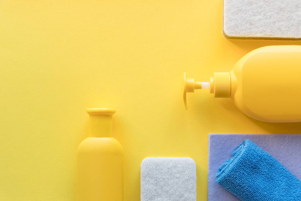 Cleaning service banner mockup. Flat lay house cleaning supplies on green background. - 写真・画像