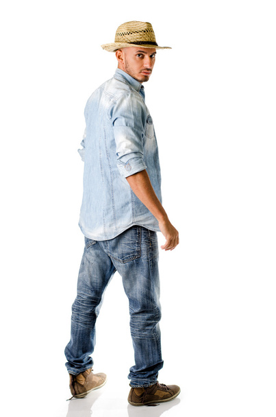 Trendy young man with jeans, denim shirt and straw hat - Foto, Imagem