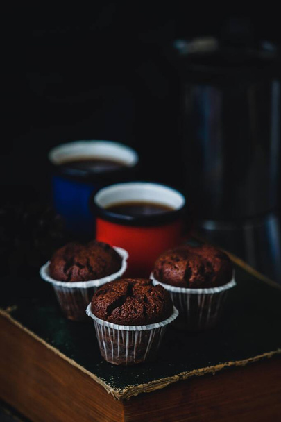 Delicious chocolate muffins, dark photography style - Фото, изображение