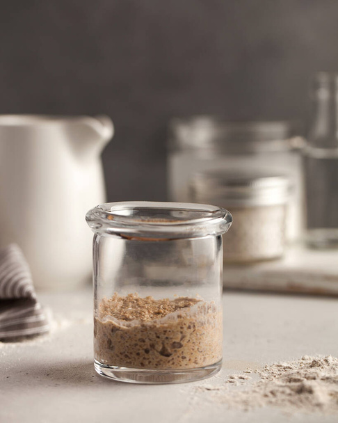  Sourdough for bread is active. Homemade rye whole grain flour sourdough. Starter leaven. Healthy eating concept.  - Фото, изображение