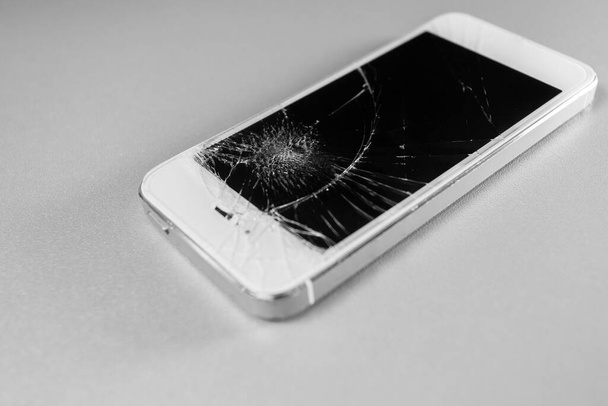 broken mobile phone display on a white background - Fotó, kép