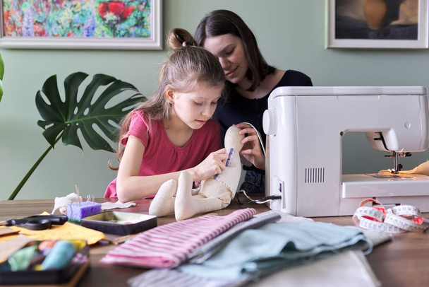 Family creative hand-made hobby and leisure, children sewing toy bunny doll - 写真・画像