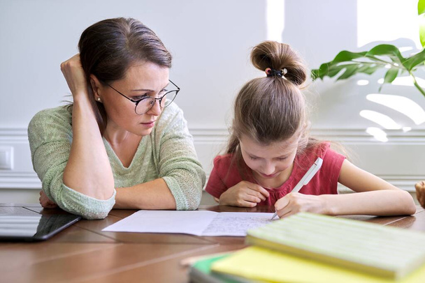 Mother and daughter child study together at home - Foto, Bild