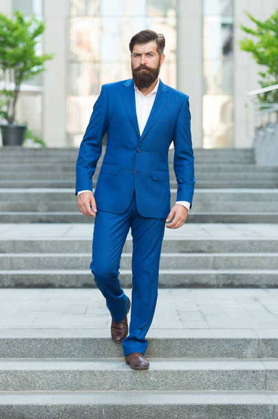 Bearded man in business centre. Confident brutal man walk street. Businessman in formal clothes. Business people. On his way to success. Walking down street. Mature hipster with beard on stairs - Fotografie, Obrázek