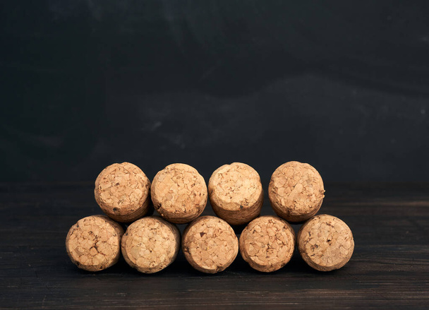 stack of corks for glass wine and champagne bottles on wooden background, copy space - Photo, Image