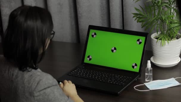 Woman have video call conference on laptop with green screen. Distance work - 映像、動画