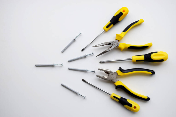 Yellow and black kit of working tools, pliers, wire cutters, dowel, screwdrivers as an idea for competition, winner, fight, aggressivity  plot - Photo, Image