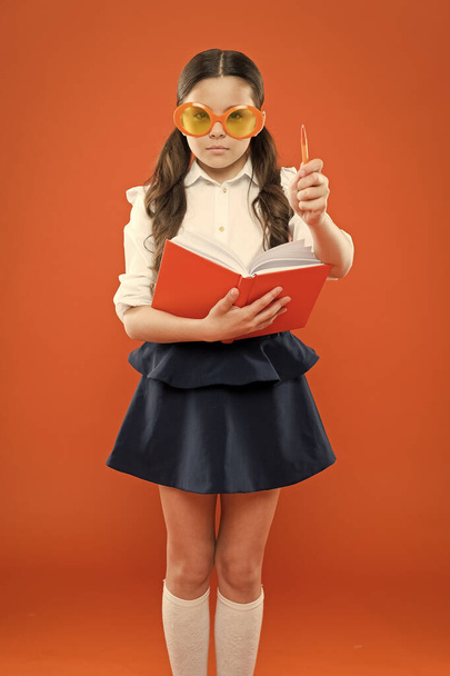 inspiration for writing. get information from book. happy school girl in uniform and party glasses. small child with notebook. literature lesson education. writing in workbook. children literature - Photo, Image