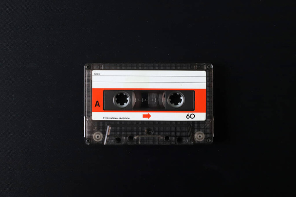 Old tape cassette, old or aged wood background. solated casette - Photo, Image