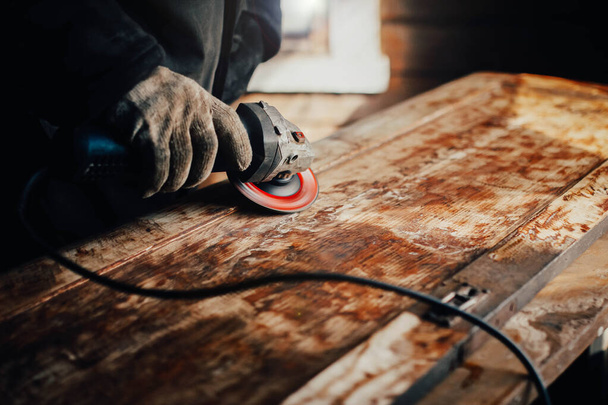 grinding with an electric wood grinder, restoration of solid wood furniture. Woodwork - Фото, зображення
