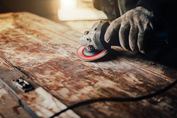 grinding with an electric wood grinder, restoration of solid wood furniture. Woodwork - Fotó, kép