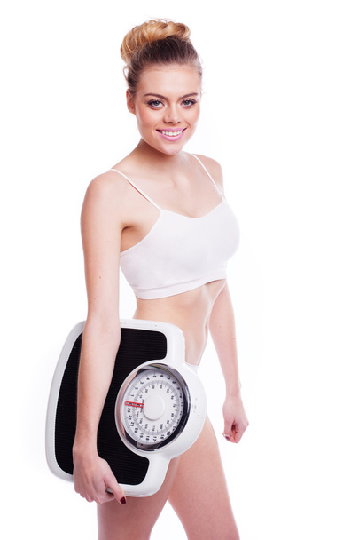 Woman with scales. Heathy weight concept. - Photo, Image